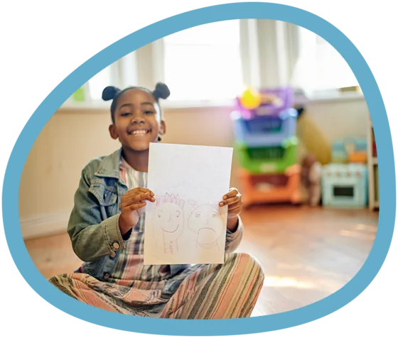Child proudly showing artwork